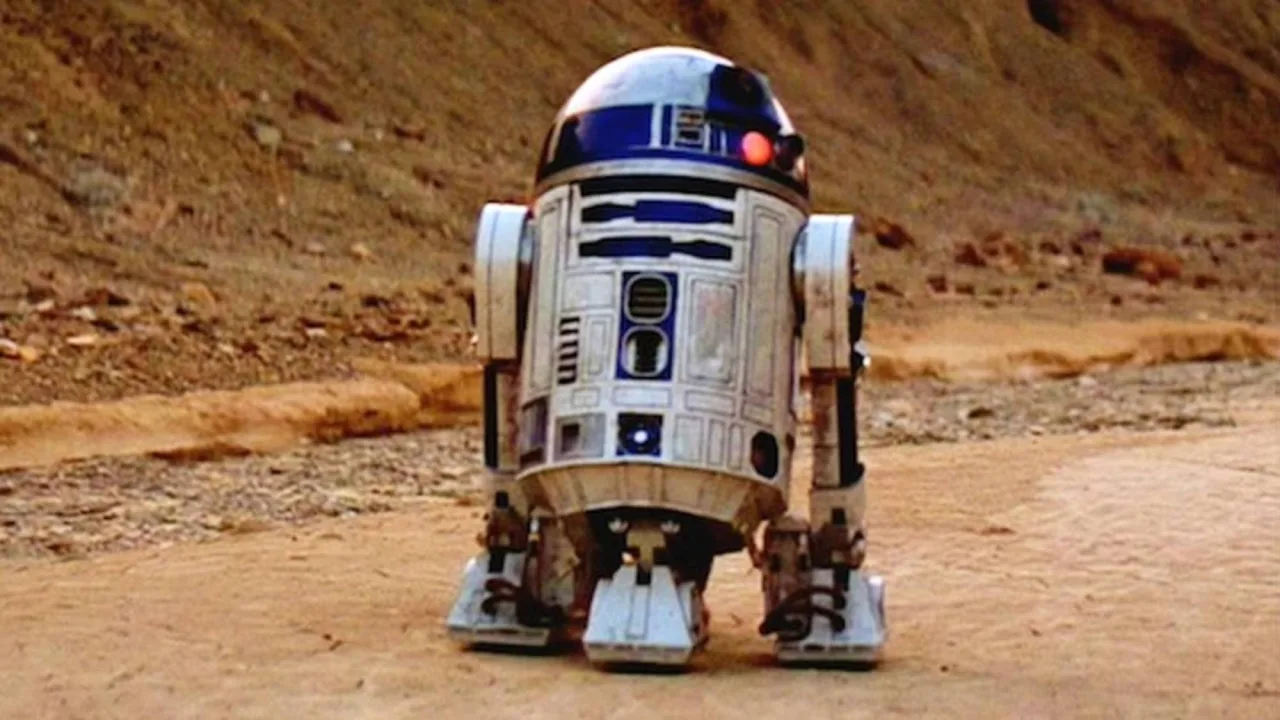 Figura de ação R2‑D2 da Kenner (1978) dentro de blister duplo com cartão 12‑Back A ao fundo