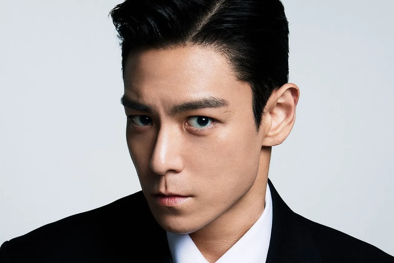 T.O.P aparece em pôster com fundo neon, segurando microfone, ao lado do logo TONZ Entertainment e data cancelada